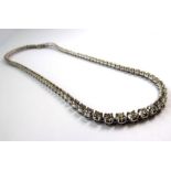 A diamond rivière necklace comprising 93 slightly graduated brilliant-cut diamonds, estimated to