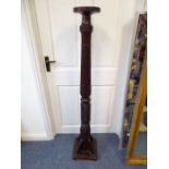 A mahogany torchère having narrow circular top (made from a four poster bed post) (141cm high)