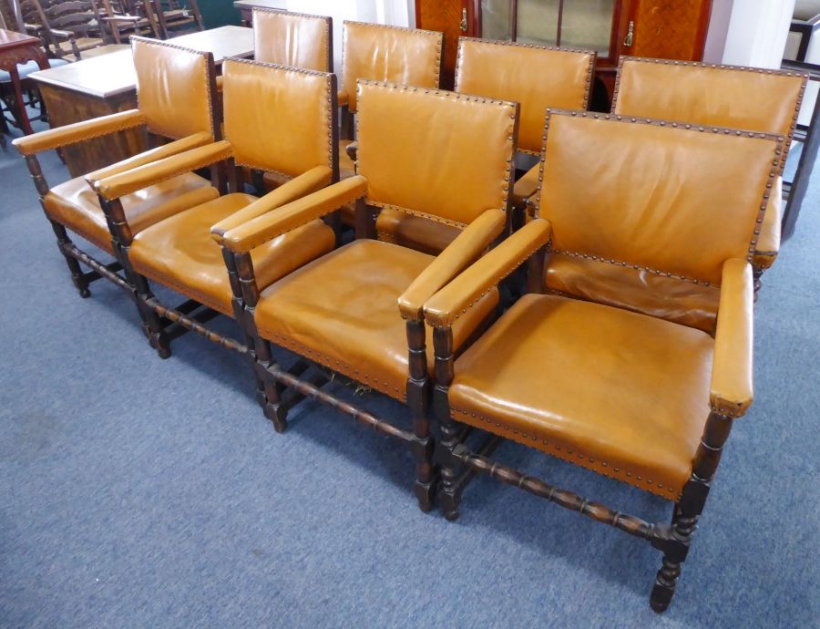 A good harlequin matched set of eight tan-leather-upholstered solid oak open armchairs;  late 19th /