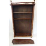 An early 20th century French walnut freestanding open bookcase; five shelves below a balustrade