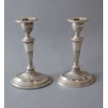 A pair of neo-classical-style silver candlesticks, hallmarked London 1899