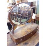 An early 19th century bow-fronted mahogany toilet mirror; three frieze drawers and raised on ogee-