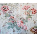 A pair of floral curtains (marked 34% linen), lined with checked material and edged with gold braid,