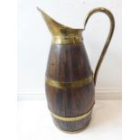 An usual late 19th / early 20th century coopered and brass mounted barrel-shaped jug of large