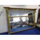 An early 19th century gilt-framed two-plate overmantle looking glass; the two outset corners