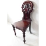 A mid-19th century mahogany hall chair; moulded serpentine-fronted seat, turned tapering legs