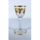 A circa 1780 wine glass with gilt decoration and facet stem (approx. 15cm high)  Condition Report: