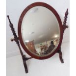 A 19th century oval mahogany-framed toilet mirror (69cm high x 54cm widest point)