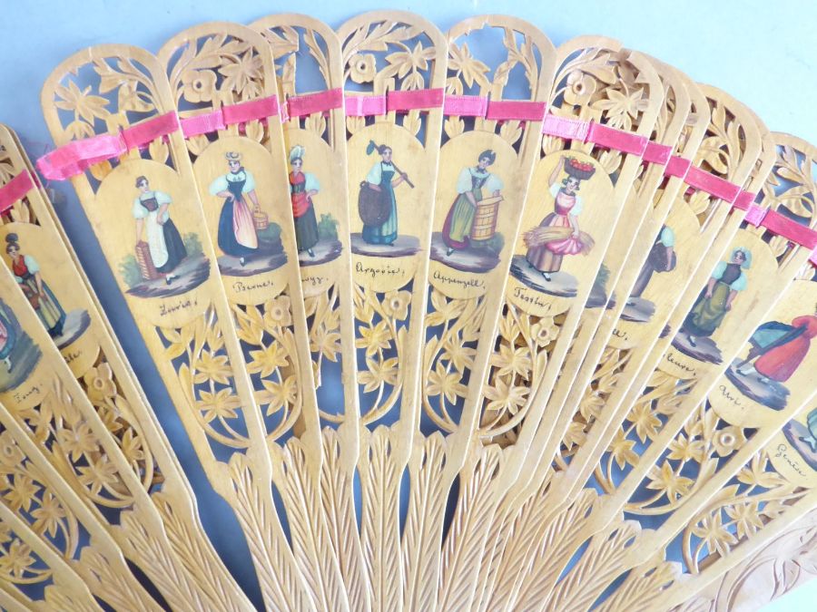 An early 20th century pierced wooden fan decorated with various Swiss costume, together with a - Image 9 of 10