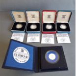 Four cased United Kingdom silver proof one pound coins struck by the Royal Mint and together with