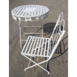 A circular latticework metal garden table and chair; both painted white and in 19th century style (