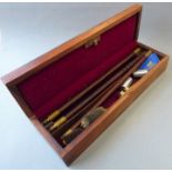 A 12-bore gun cleaning kit in its stained-ash box: three-piece rod, jag, two brushes and snap caps