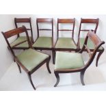 A set of six early 19th century dining chairs; tablet-shaped concave top rails, drop-in