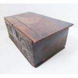 A late 17th century oak chest; the top with original strap hinges above a frieze incised and