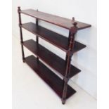 A late Regency period set of stained-pine wall-hanging shelves; four shelves flanked by slender