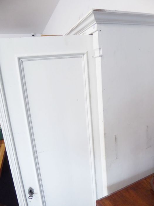 A Continental-style two-door pine wardrobe; white-painted, raised on turned feet, probably early - Image 2 of 4