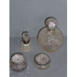 A 19th century cut-glass spherical scent bottle with silver-mounted repoussé lid, another smaller