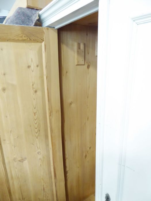 A Continental-style two-door pine wardrobe; white-painted, raised on turned feet, probably early - Image 3 of 4