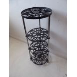 A four-tier cast-iron circular Aga stand (85cm high x 28cm diameter)