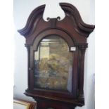 An 18th century oak-cased eight-day longcase clock; the broken swan-neck pediment above a 12-inch