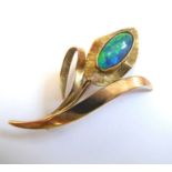 A 9-carat yellow gold brooch; modelled as leaves and an oval flowerhead set with an opal (within