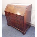 A good late 18th century mahogany writing bureau; the crossbanded fall opening to reveal fully