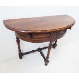 An antique mahogany credence-style table; the overhanging demi-lune top above two hinged quadrant