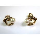 A pair of earrings modelled as jumping dolphins with pearls (possibly silver gilt) (within