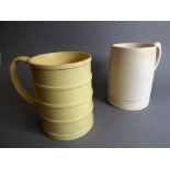 KEITH MURRAY for Wedgwood; two early 20th century tankards, both with printed marks to their