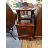 An Edwardian mahogany perdonium; having mirrored back and carved square section