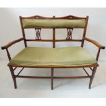 An early 20th century two-seater stained-wood canopy in loose Sheraton Revival style; the double top