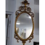 A modern gilt composition framed wall-hanging oval looking glass in late 18th century-style