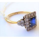 A sapphire and diamond-set ring, the rectangular-cut sapphire within a border of brilliant-cut