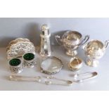 A selection of silver plate: a matching cream jug and sugar, a pair of salts with green-glass