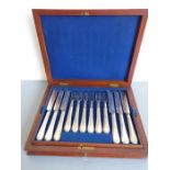 A late 19th century twelve-place silver-plated tea knife and fork set; each handle engraved with