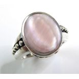 A heavy silver dress ring set with a polished oval mother-of-pearl-style stone (ring size Q) (