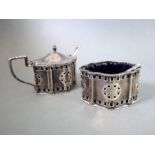 An early 20th century silver mustard with blue-glass liner and matching salt, both with