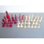 Various 19th century red-stained and natural ivory chess pieces to include four red pawns, three