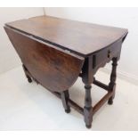 An early 18th century oval oak drop-leaf gateleg table; single end-drawer with ovolo mouldings and