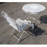 A circular metal garden table and chair; the table (78cm diameter) with central floral-style inset