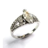 A marquise and diamond-set ring, the central marquise diamond estimated to spread 0.70 carats to the