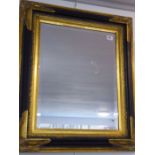 An antique-style (reproduction) wall-hanging looking glass; parcel-gilt frame and hand-bevelled