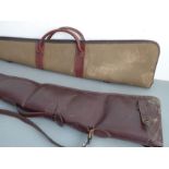 Two gun slips: leather and faux sheepskin lined (129cm) and padded canvas-type and leather (127cm)