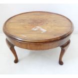 A circa 1920 circular figured walnut occasional table; raised on four cabriole legs, some heating