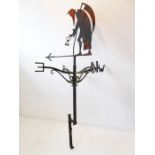 A large wrought-iron weather vane; surmounted with a figure of Old Father Time and wall-mounting