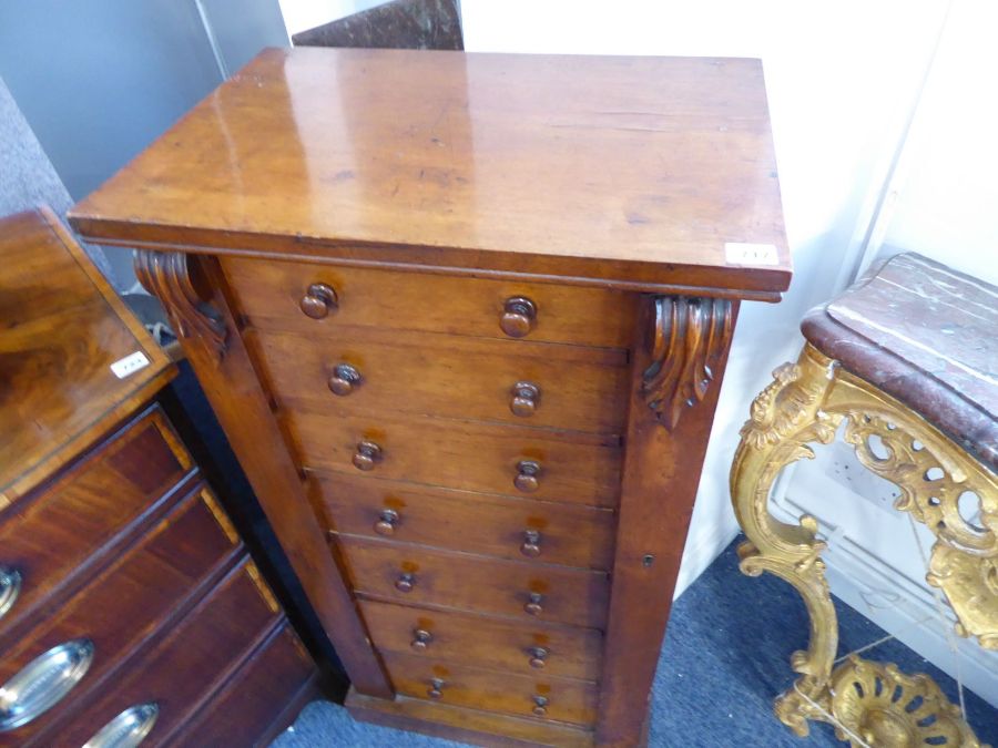 A 19th century mahogany Wellington chest; the two verticals carved at the top with volutes and the - Image 2 of 6