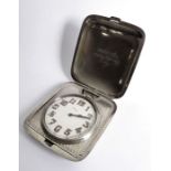 An early 20th century sterling silver-cased eight-day travelling clock; white-enamel dial (