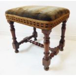An antique (in 17th century style) walnut stool; the turned supports united by a similarly turned