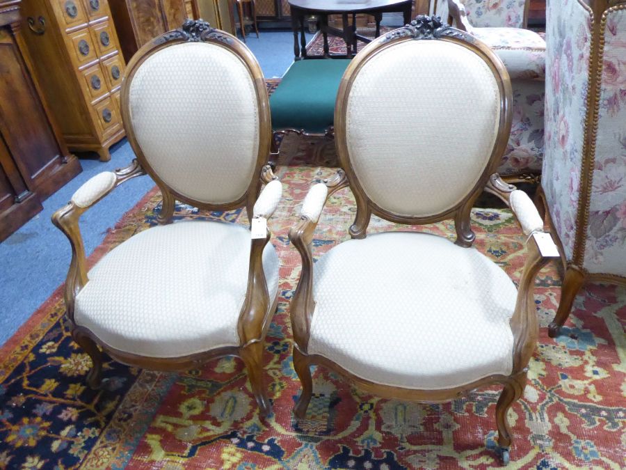 A pair of 19th century spoon back open armchairs in mid / late 18th century French style; the top-