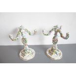 A pair of late 19th century German porcelain three-light candelabra (some damage); the removeable